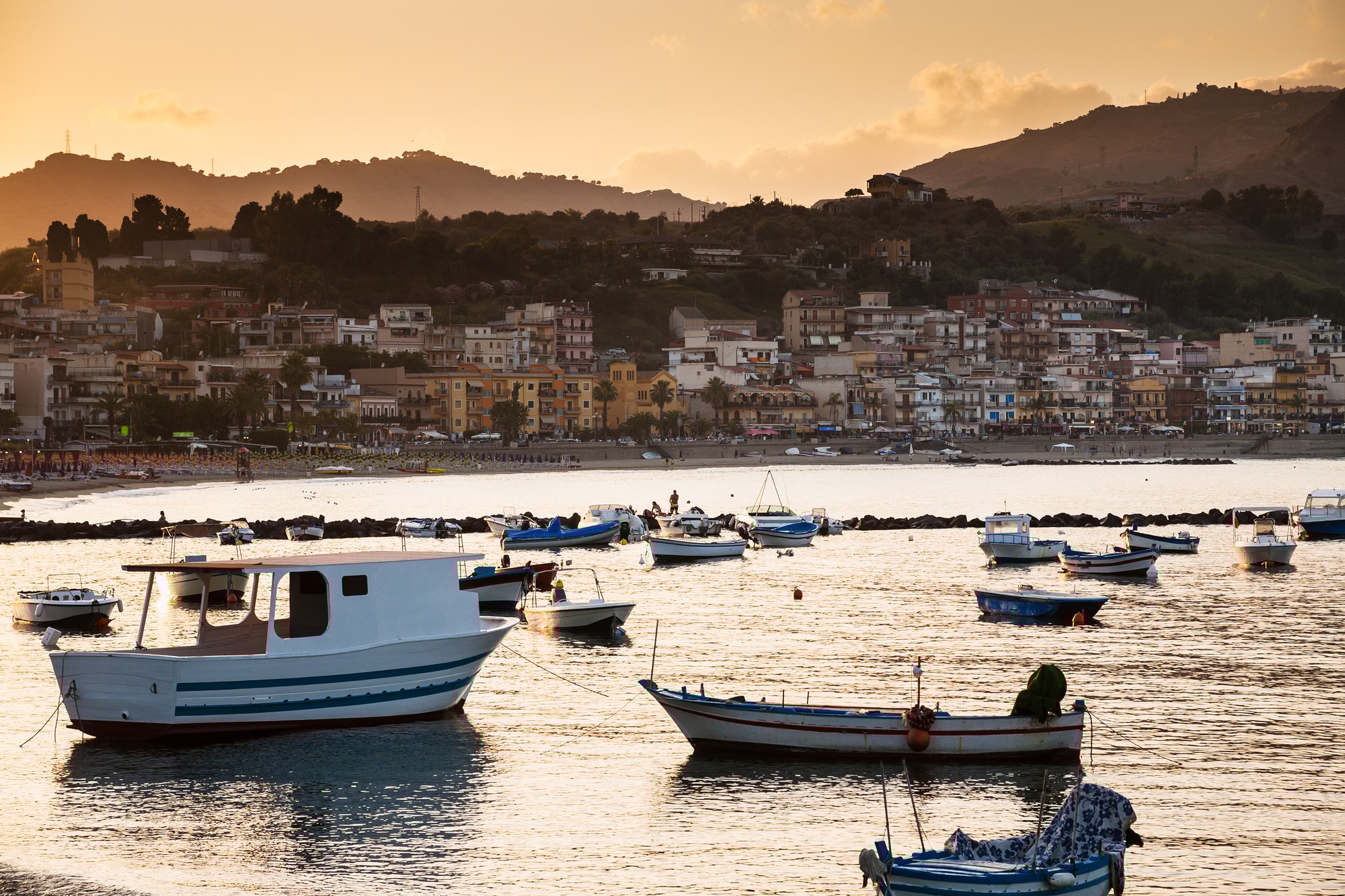 boats in marina of Giardini Naxos town on sunset