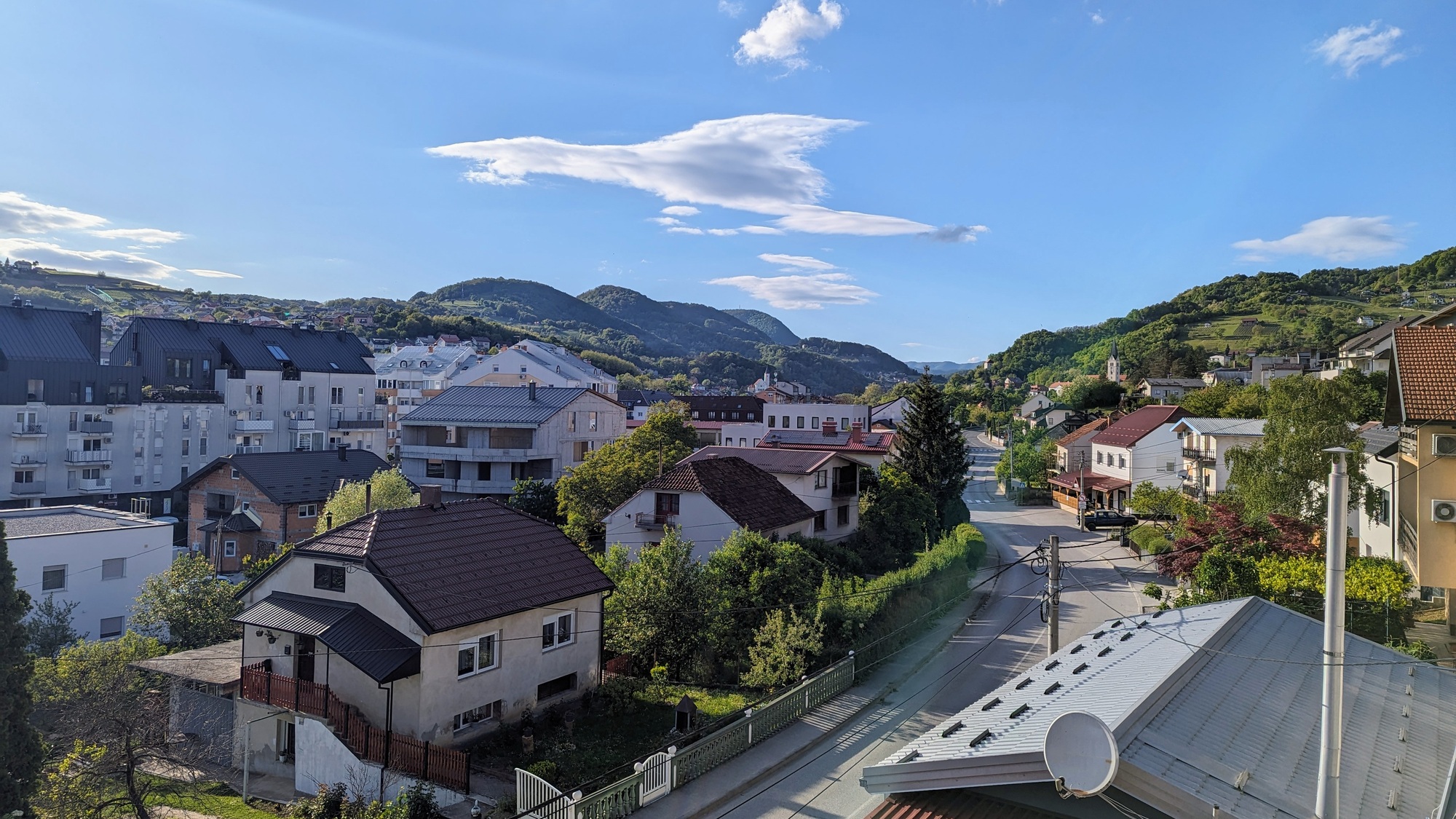 Cityscape surrounded by green hills and forest under blue sky, Krapina city, Croatia, Hrvatsko zagor
