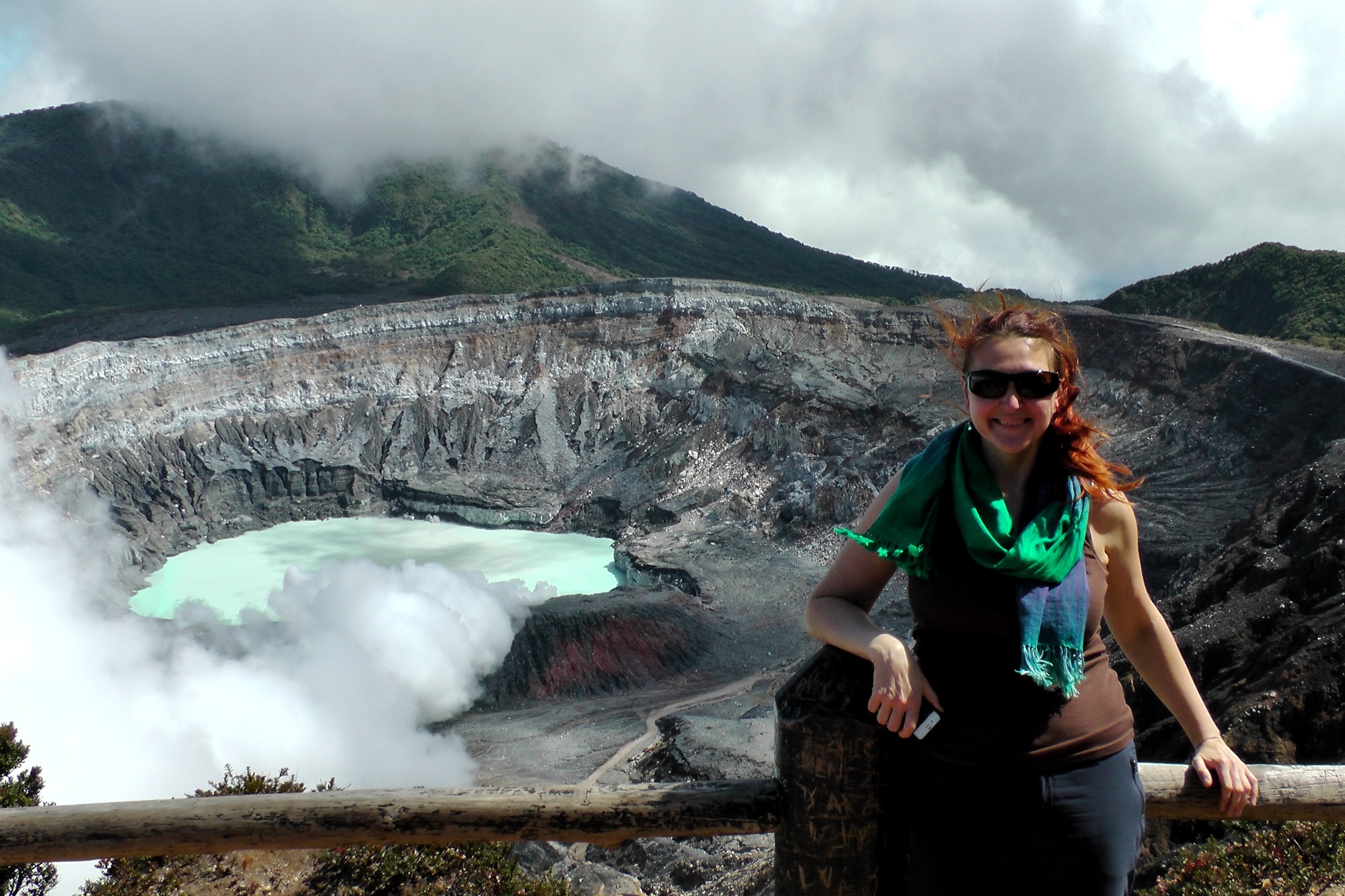 Woman traveling to exotic destinations, hiking to exposed volcano crater to witness natural wonders
